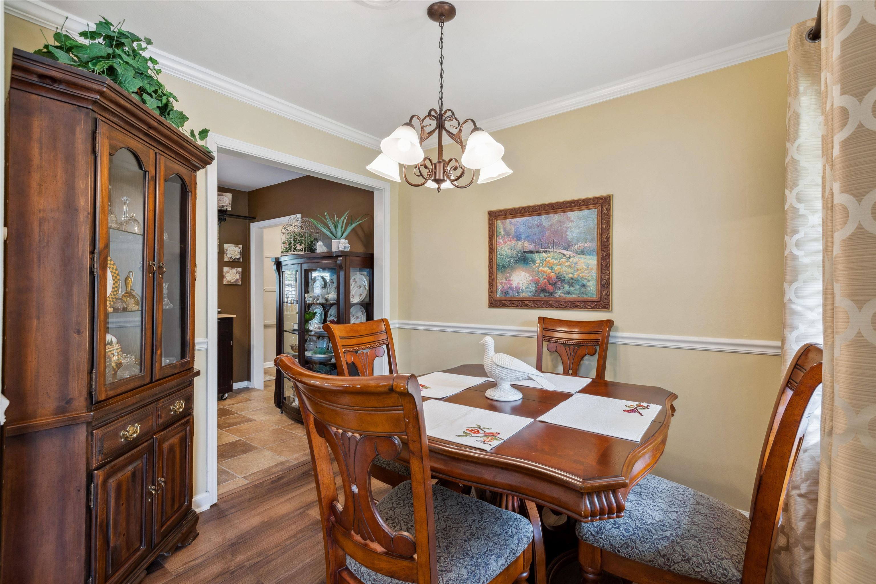 1631 Hopewell Road Memphis, TN 38117 - Photo 6 of 22 a dining room with furniture a chandelier and wooden floor