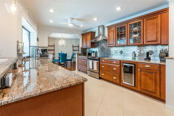 a kitchen with stainless steel appliances granite countertop sink stove and refrigerator