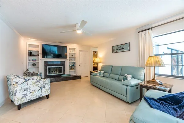 a living room with furniture flat screen tv and a fireplace