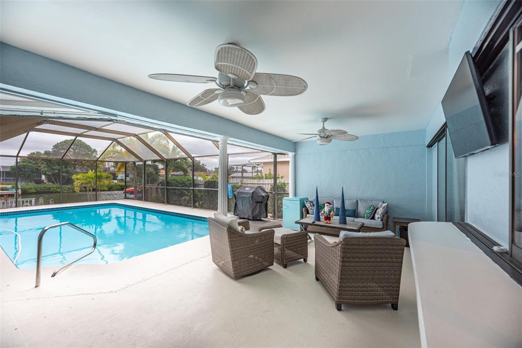 910 Chipaway Drive Apollo Beach, FL 33572 - Photo 20 of 39 a living room with furniture a chandelier and a flat screen tv