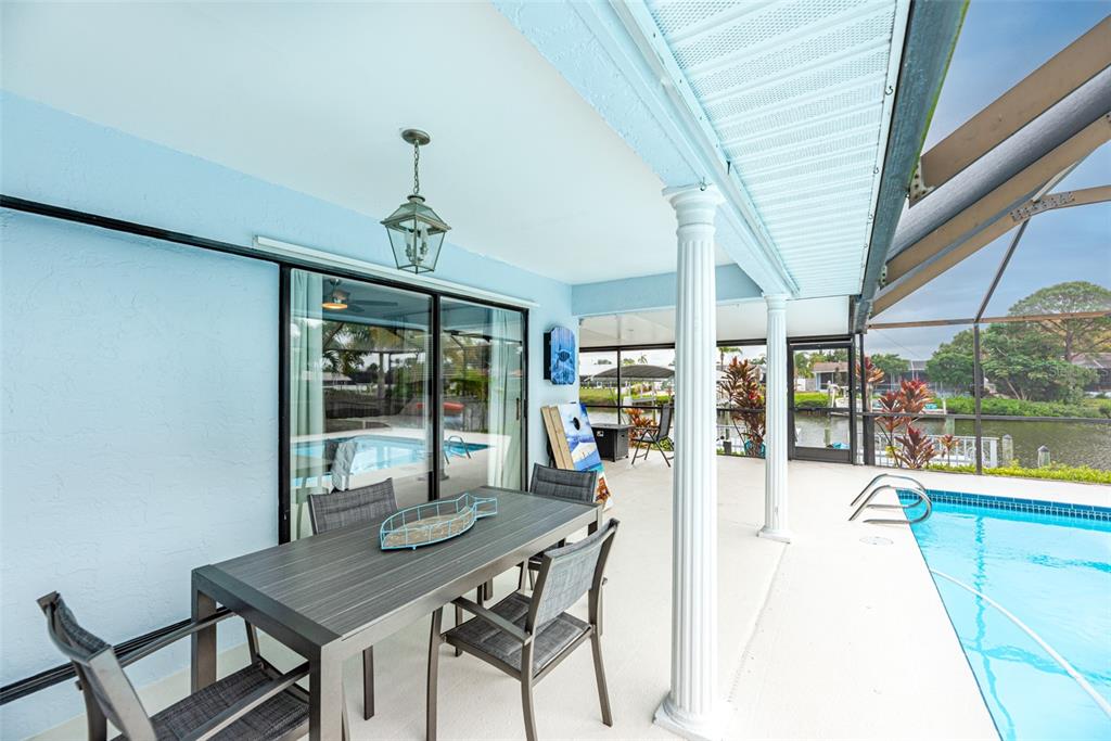 910 Chipaway Drive Apollo Beach, FL 33572 - Photo 24 of 39 a dining room with furniture a chandelier and a rug