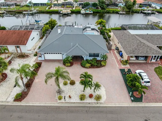 an aerial view of a house with outdoor space and lake view