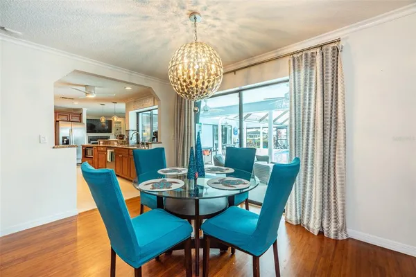 a view of a dining room with furniture wooden floor and chandelier