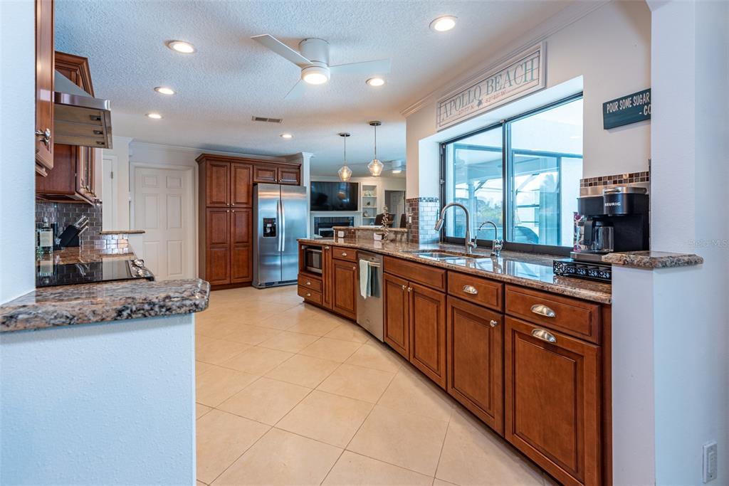 910 Chipaway Drive Apollo Beach, FL 33572 - Photo 10 of 39 a large kitchen with stainless steel appliances kitchen island granite countertop a large counter top cabinets and a sink