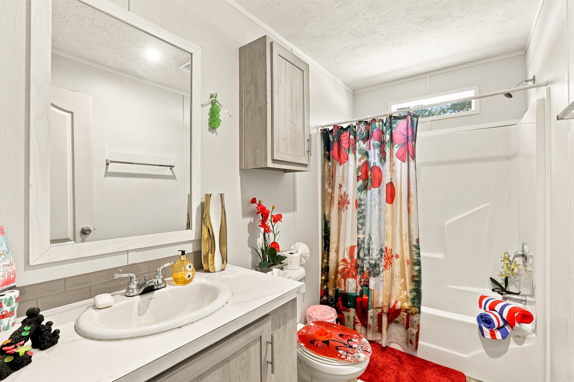 1039 Trailside Elgin, TX 78621 - Photo 15 of 24 An inviting bathroom offers structured cabinetry, stone countertops, and a modern tub shower surround.