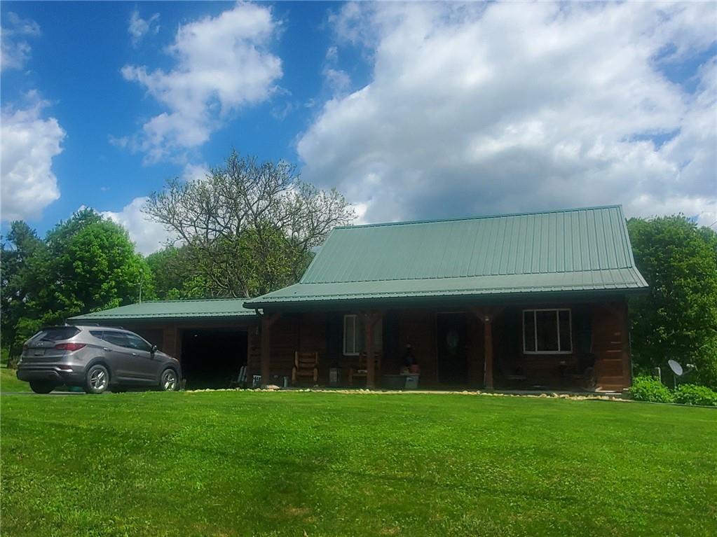 132 Laird's Crossing Road Worthington, PA 16262 - Photo 1 of 20 a front view of a house with a garden and trees
