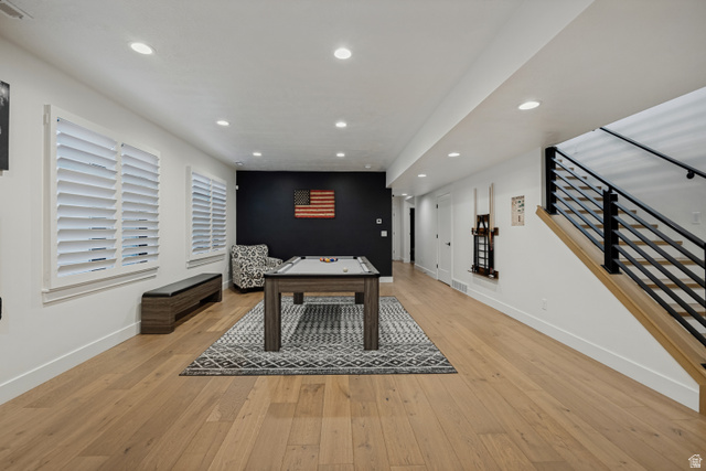 13257 Sky Rnch Road Herriman, UT 84096 - Photo 10 of 17 Expansive entertainment space featuring light wood-finish flooring, recessed lighting, and white plantation shutters