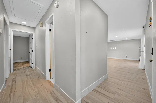 a view of a hallway with wooden floor