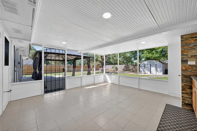 a large space with a large window and swimming pool