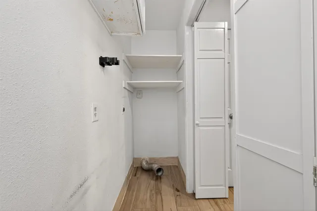 a view of walk in closet with clothes