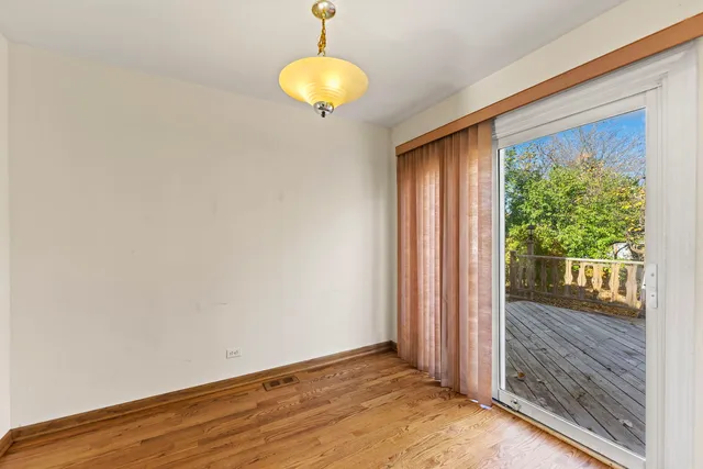 a view of a room with wooden floor and iron gate