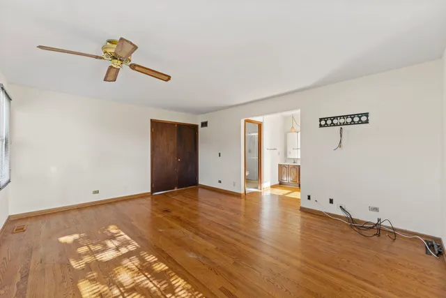 a view of a room with wooden floor and white walls