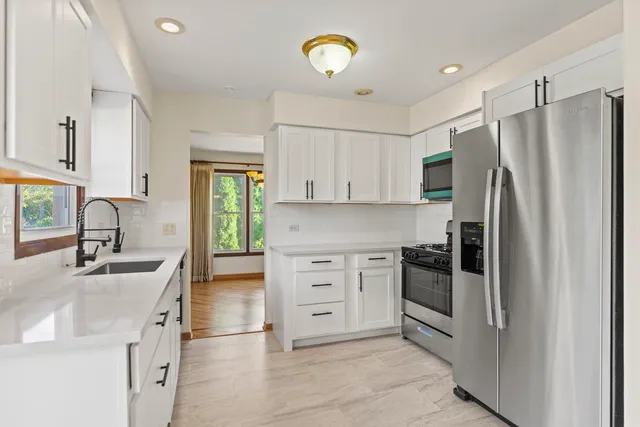 a kitchen with cabinets stainless steel appliances and a counter space