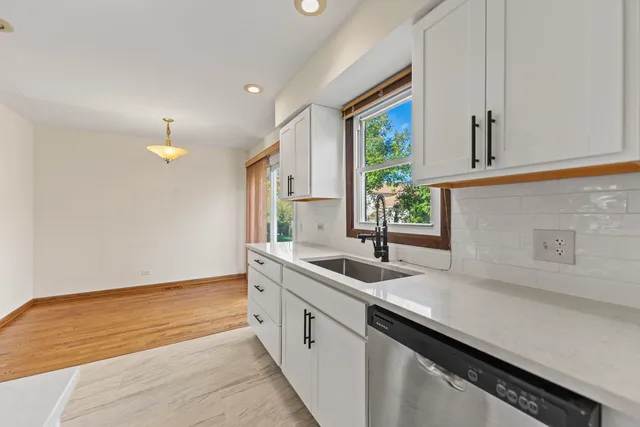 a kitchen with a sink cabinets and window