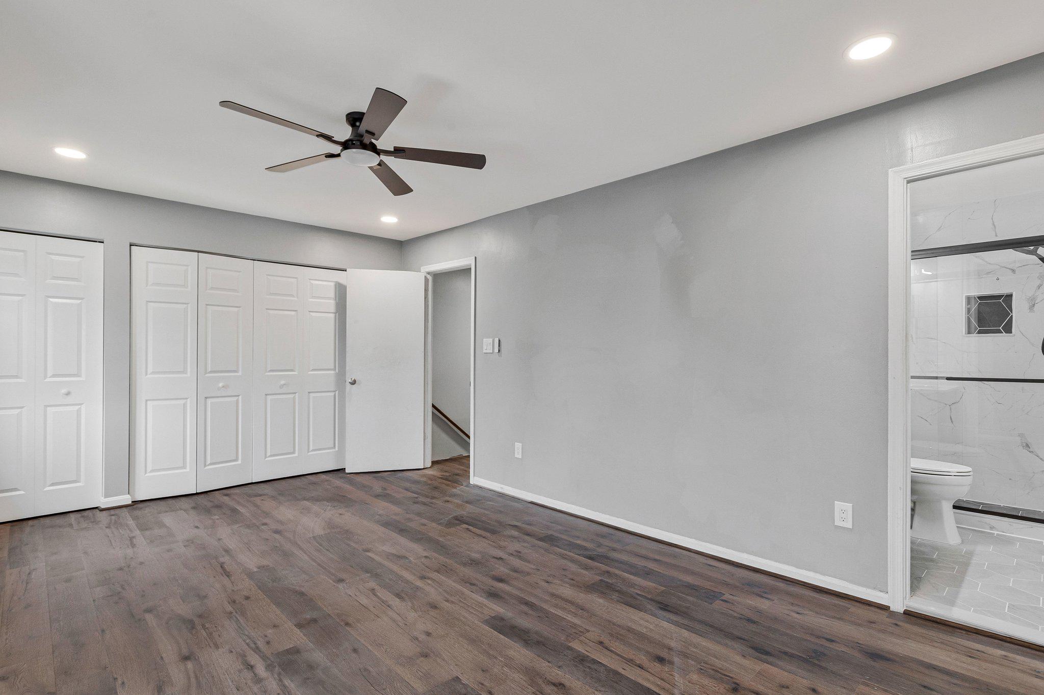1675 Ridgely Court, Unit 182 Crofton, MD 21114 - Photo 31 of 47 a view of an empty room with wooden floor and a ceiling fan