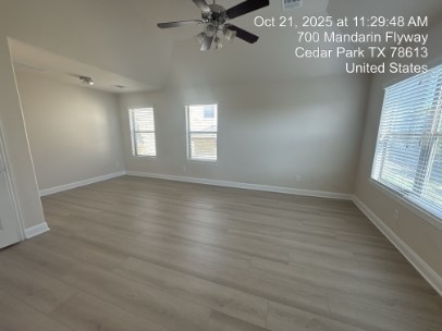 700 Mandarin Flyway, Unit 1401 Cedar Park, TX 78613 - Photo 11 of 27 Empty room with light wood-style flooring, ceiling fan, and vaulted ceiling