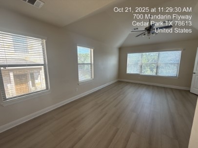 700 Mandarin Flyway, Unit 1401 Cedar Park, TX 78613 - Photo 12 of 27 Spare room with wood finished floors, plenty of natural light, vaulted ceiling, and a ceiling fan