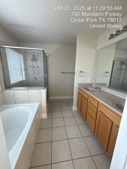 700 Mandarin Flyway, Unit 1401 Cedar Park, TX 78613 - Photo 14 of 27 Full bathroom with double vanity, a stall shower, light tile patterned floors, and a bath
