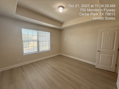 700 Mandarin Flyway, Unit 1401 Cedar Park, TX 78613 - Photo 17 of 27 Spare room with a raised ceiling and wood finished floors