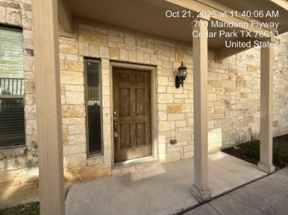 700 Mandarin Flyway, Unit 1401 Cedar Park, TX 78613 - Photo 26 of 27 Property entrance featuring stone siding and covered porch