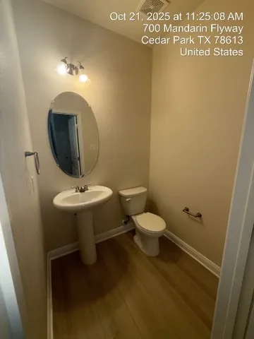a bathroom with a toilet sink and mirror