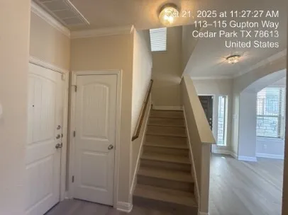 a view of a hallway with wooden floor and staircase