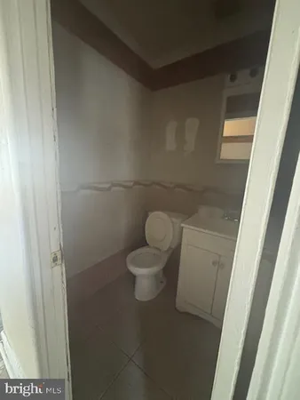 a kitchen with granite countertop a refrigerator and a sink