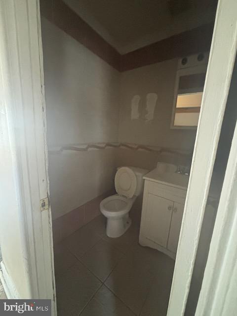 5104 Emo Street Capitol Heights, MD 20743 - Photo 8 of 24 a white toilet sitting in a bathroom next to a wooden door