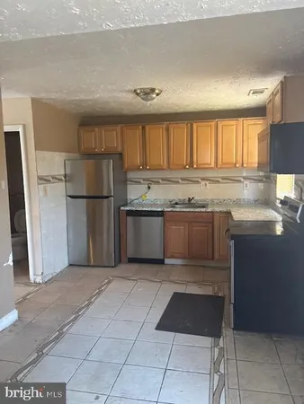 a kitchen with a sink and a refrigerator