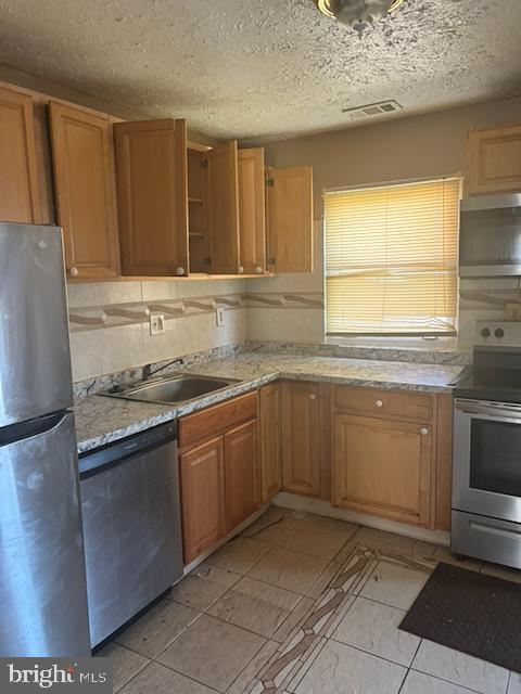 5104 Emo Street Capitol Heights, MD 20743 - Photo 10 of 24 a kitchen with a sink and a refrigerator
