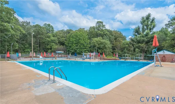 a view of a swimming pool with outdoor seating