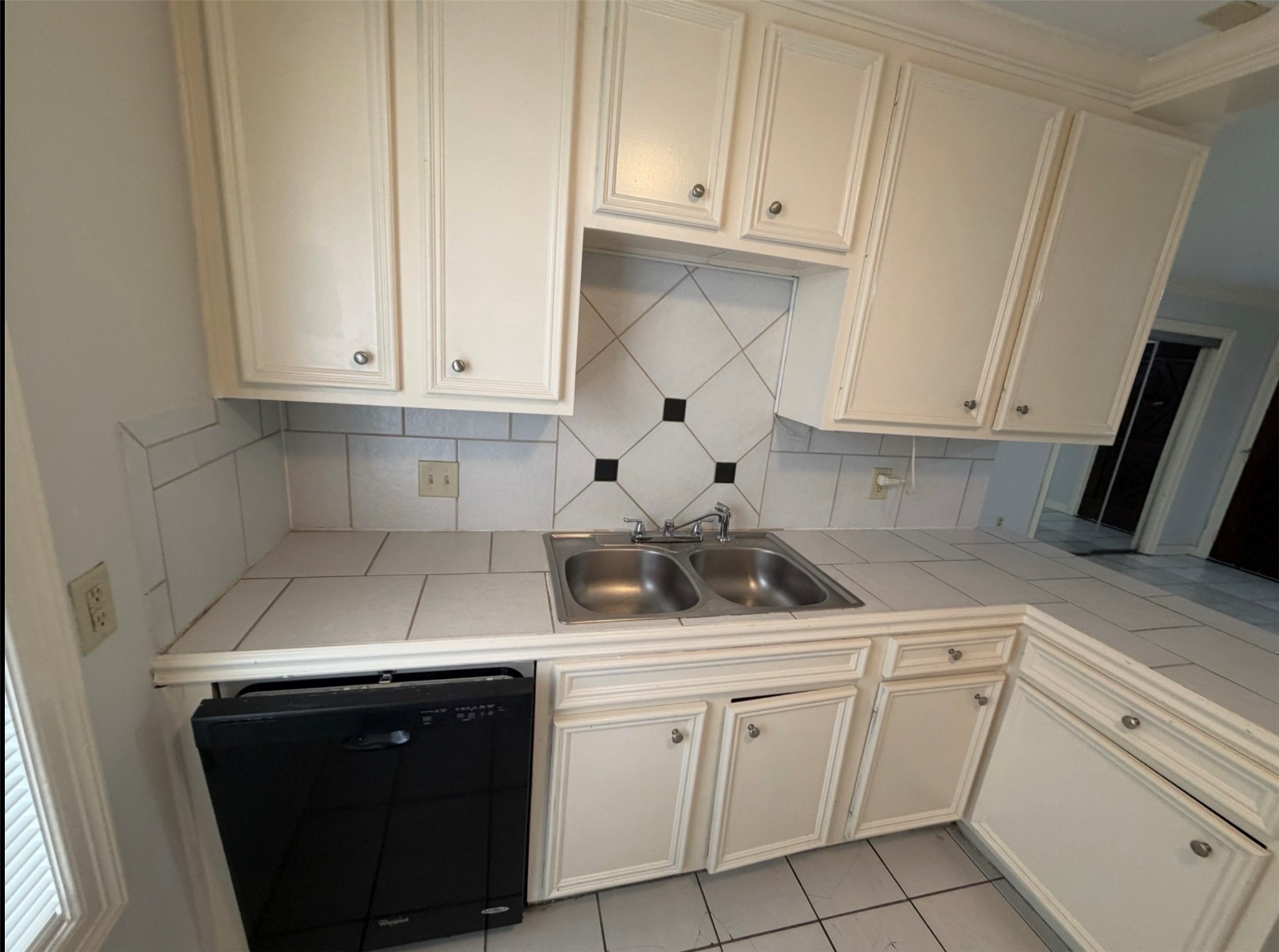 613 Pacific Street, Unit 1 Houston, TX 77006 - Photo 14 of 28 a kitchen with white cabinets and sink