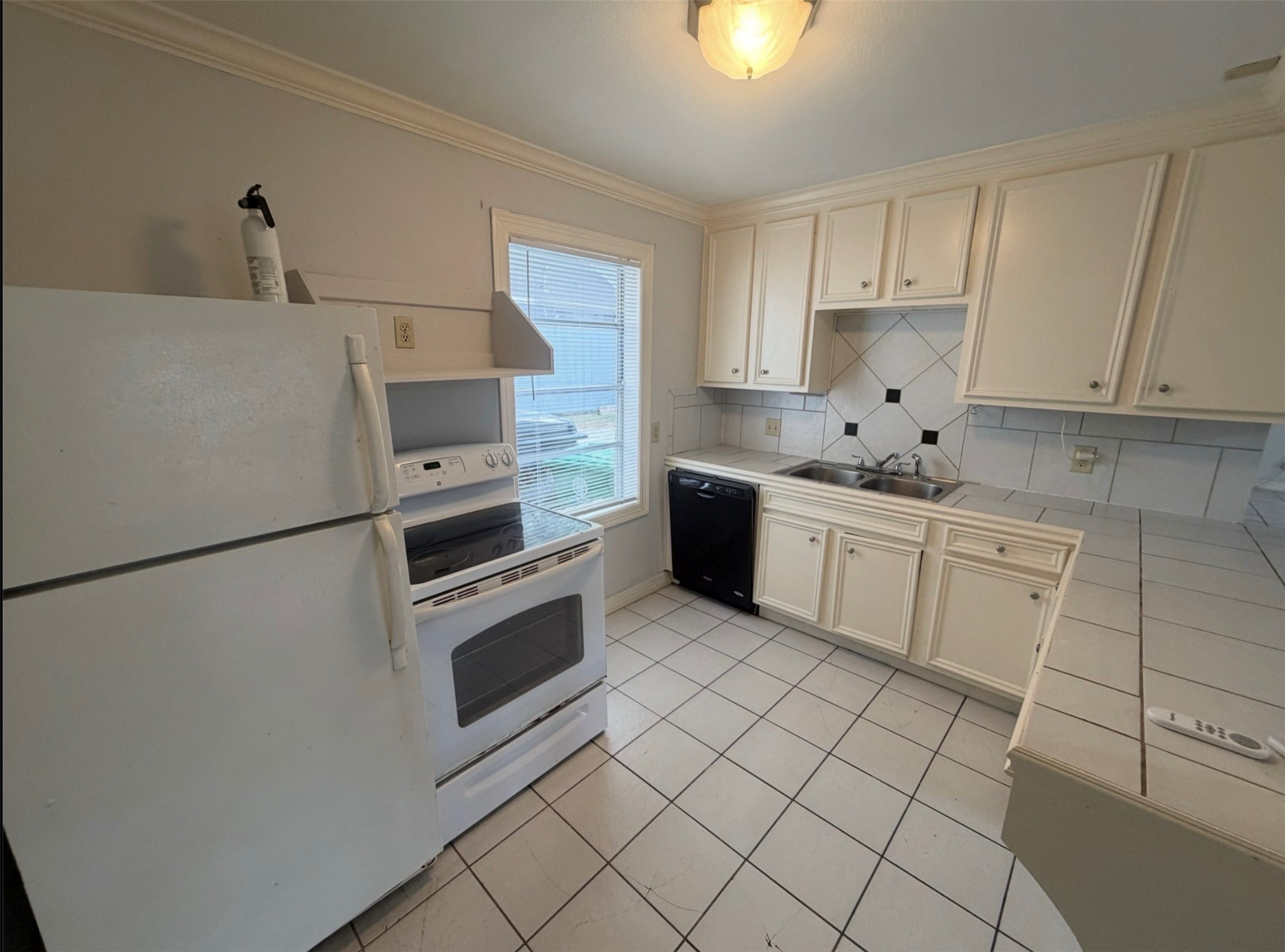 613 Pacific Street, Unit 1 Houston, TX 77006 - Photo 17 of 28 a kitchen with white cabinets and white appliances