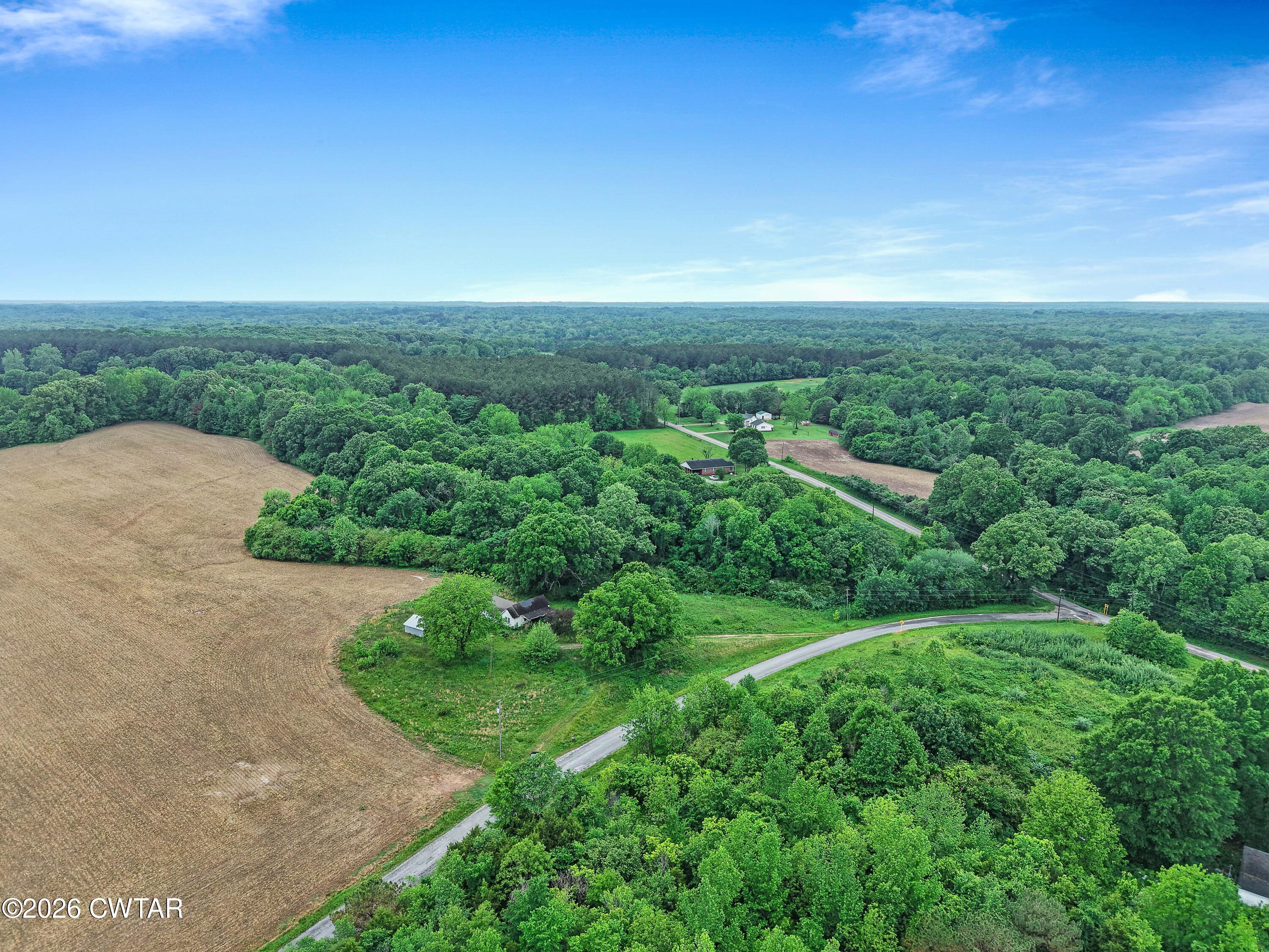 1525 Mill Creek Road Cedar Grove, TN 38321 - Photo 4 of 15 an aerial view of green landscape with trees houses and mountain view