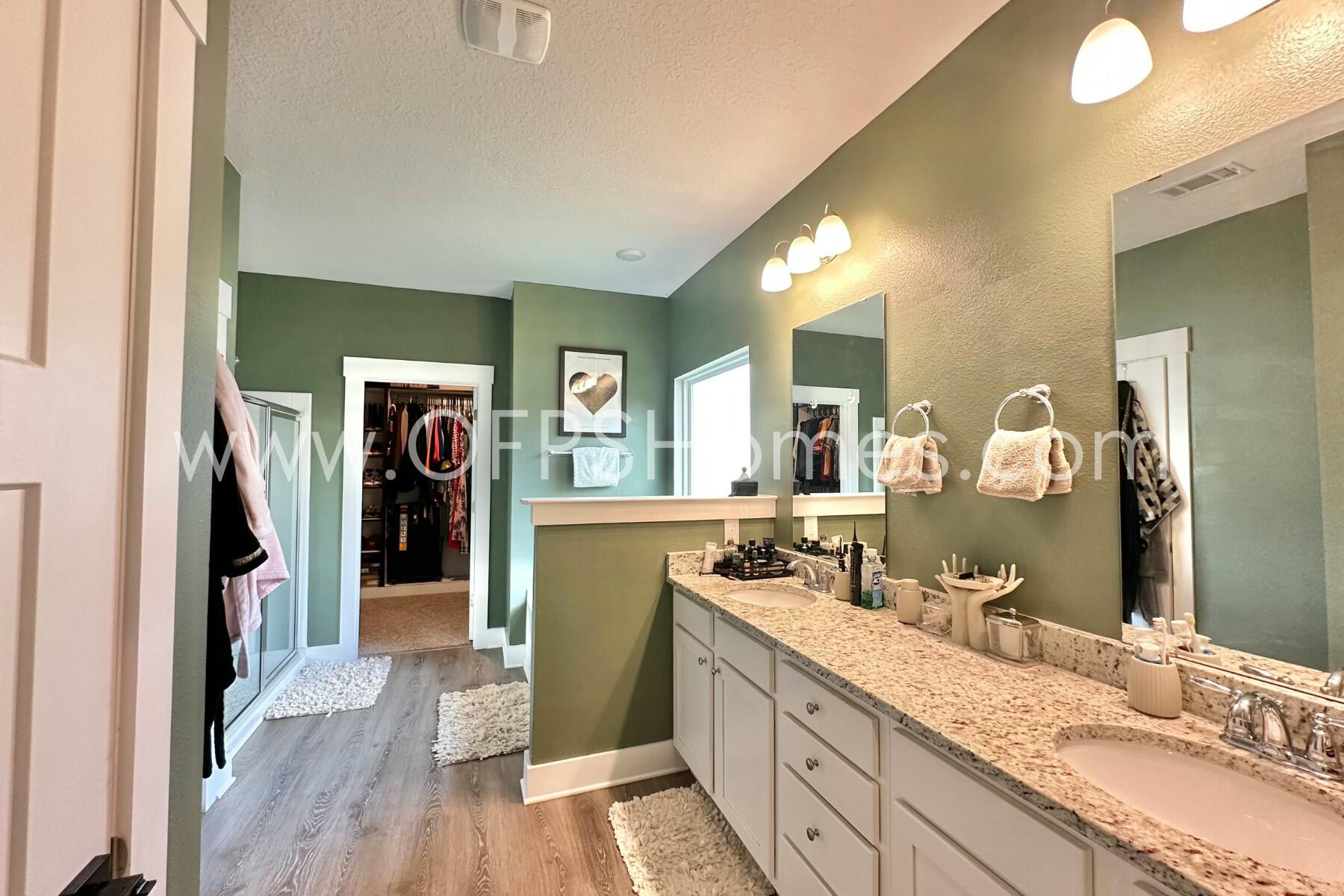2412 Dakota Way Crestview, FL 32536 - Photo 15 of 43 a bathroom with a granite countertop sink mirror and shower