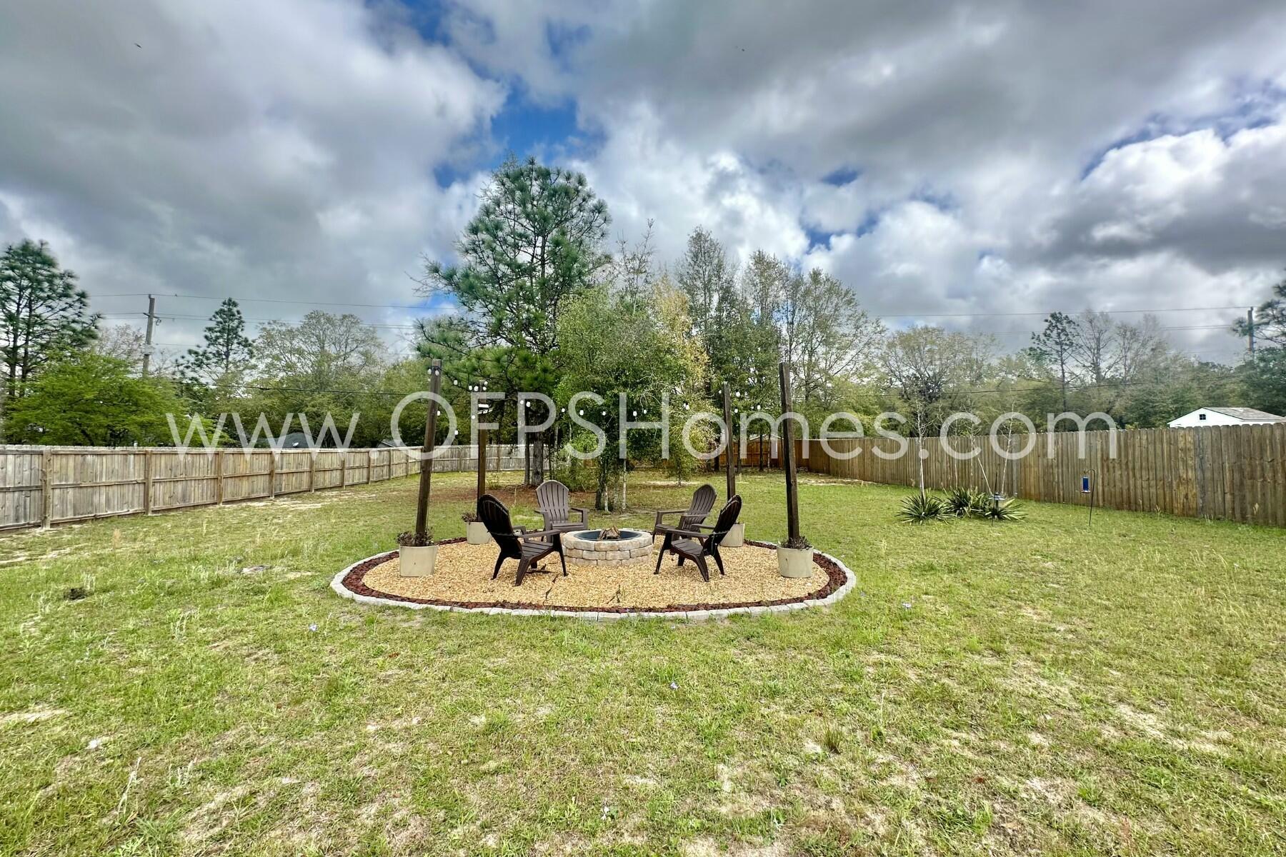 2412 Dakota Way Crestview, FL 32536 - Photo 16 of 43 a backyard of a house with a yard and outdoor seating