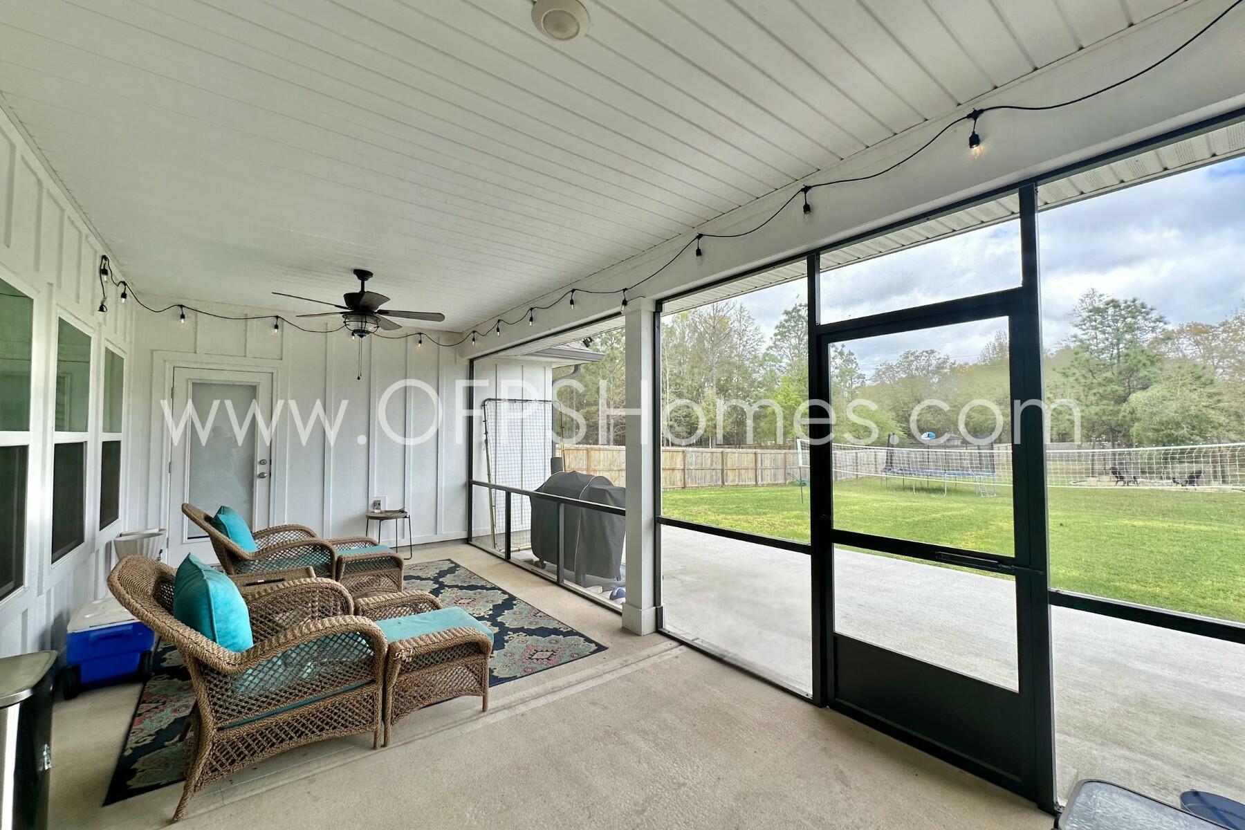 2412 Dakota Way Crestview, FL 32536 - Photo 20 of 43 a living room with furniture and a floor to ceiling window