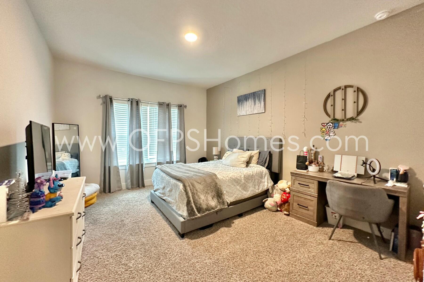 2412 Dakota Way Crestview, FL 32536 - Photo 2 of 43 a spacious bedroom with a bed and a flat tv screen on the dresser