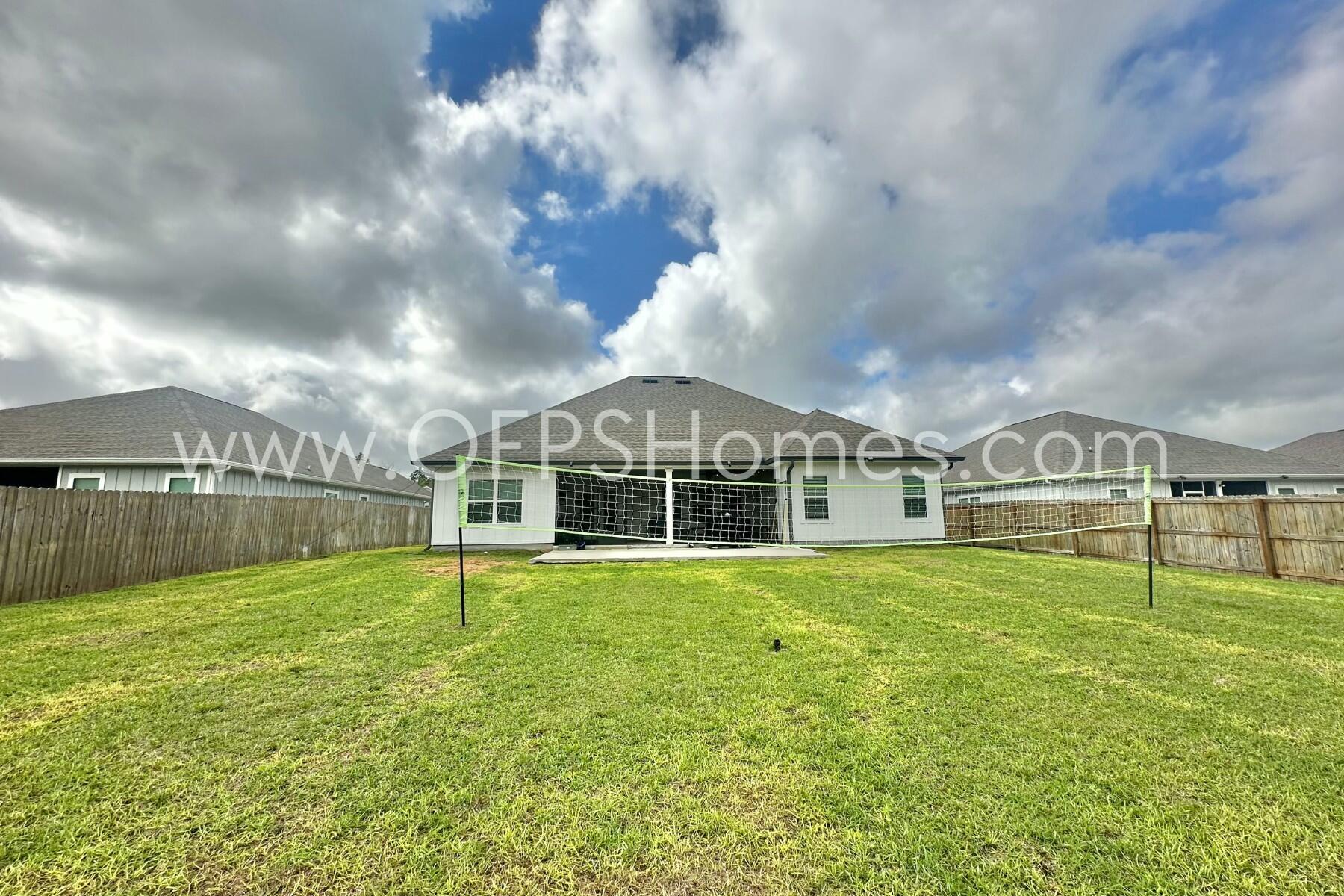 2412 Dakota Way Crestview, FL 32536 - Photo 24 of 43 a view of a big house with a big yard and large trees