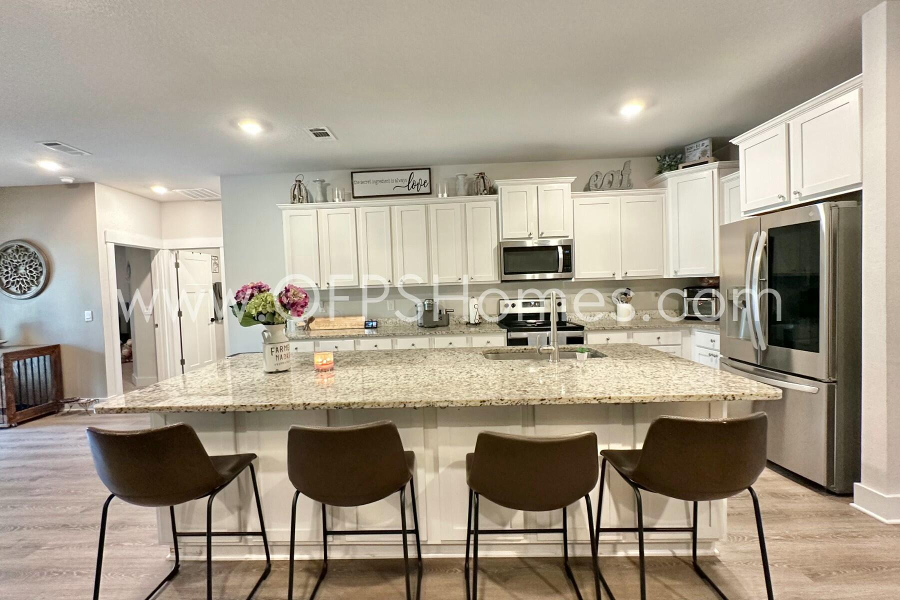 2412 Dakota Way Crestview, FL 32536 - Photo 26 of 43 a large kitchen with granite countertop a sink and cabinets