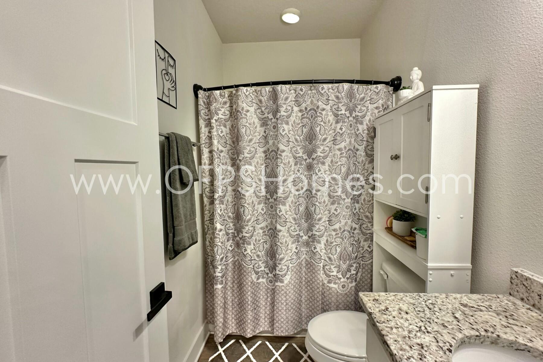 2412 Dakota Way Crestview, FL 32536 - Photo 31 of 43 a bathroom with a toilet and shower curtain