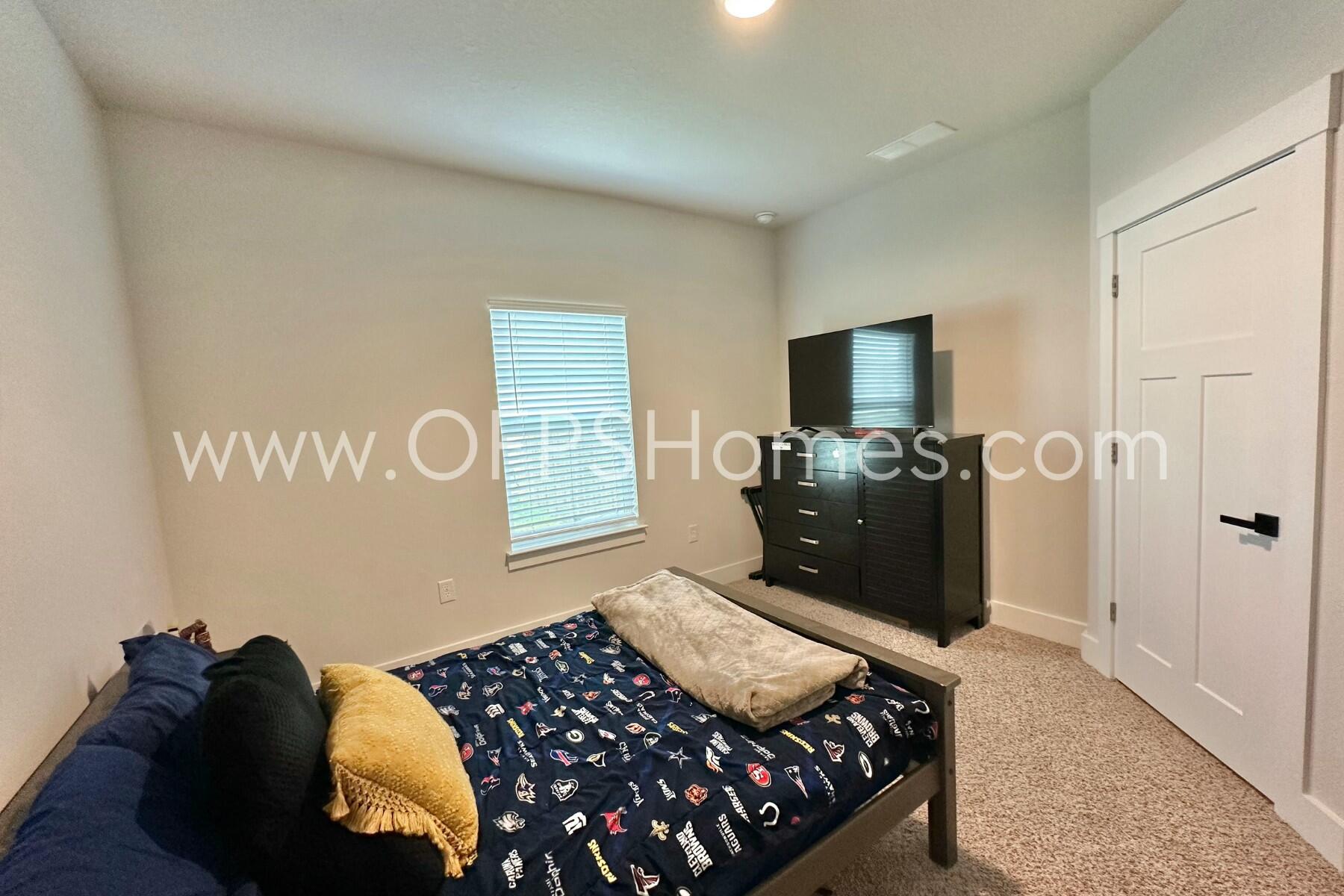 2412 Dakota Way Crestview, FL 32536 - Photo 39 of 43 a bedroom with a bed and wooden floor