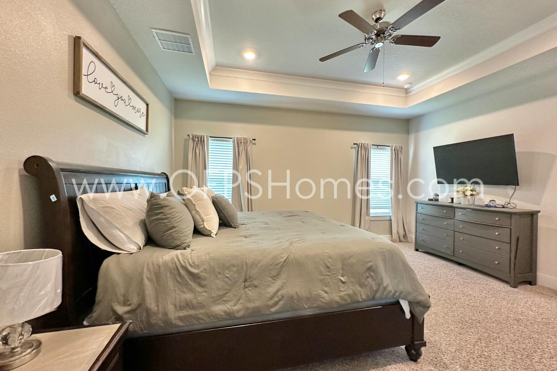 2412 Dakota Way Crestview, FL 32536 - Photo 4 of 43 a bedroom with a large bed and flat tv