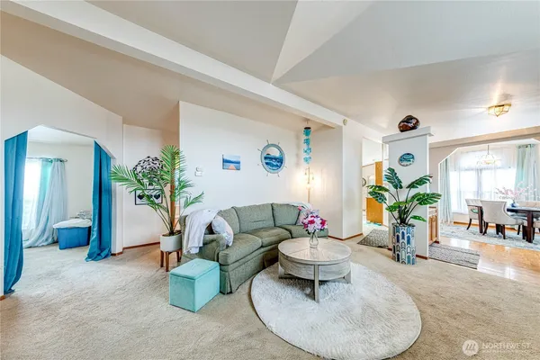 a living room with furniture and potted plant