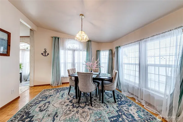 a view of a dining room with furniture window and wooden floor