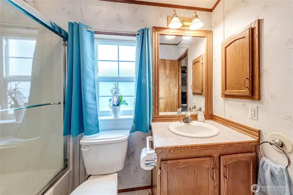 a bathroom with a sink toilet and shower