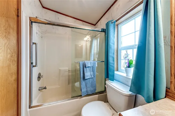 a bathroom with a toilet and shower