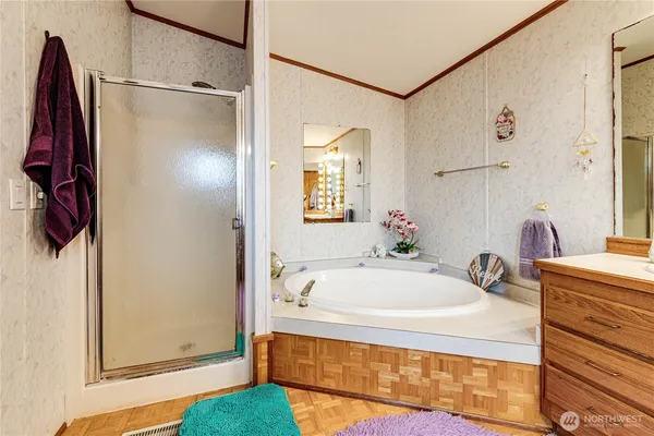 a bathroom with a tub sink and mirror