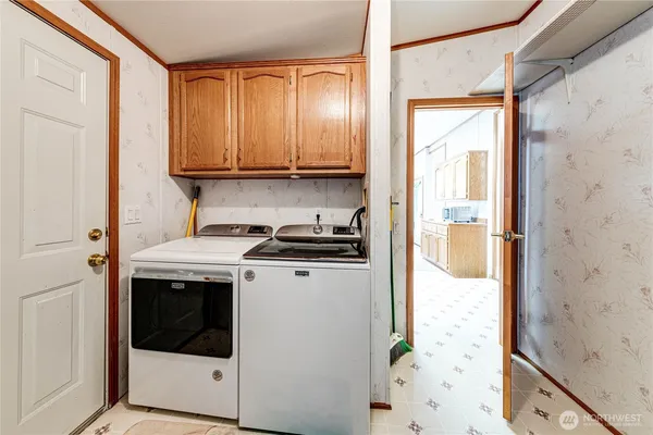 a view of a kitchen with washer and dryer