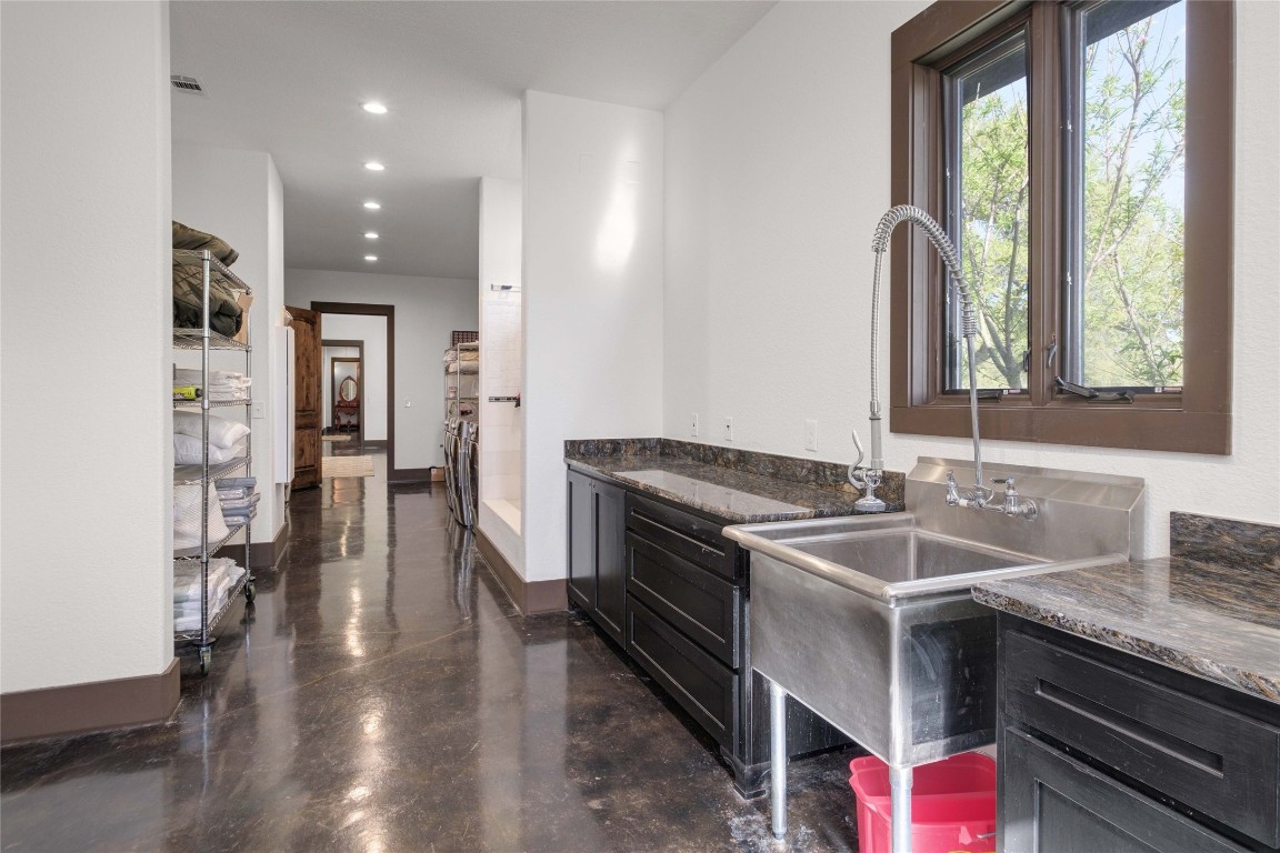 9770 Farm To Market 967 Buda, TX 78610 - Photo 17 of 40 a kitchen with stainless steel appliances granite countertop a sink stove and cabinets
